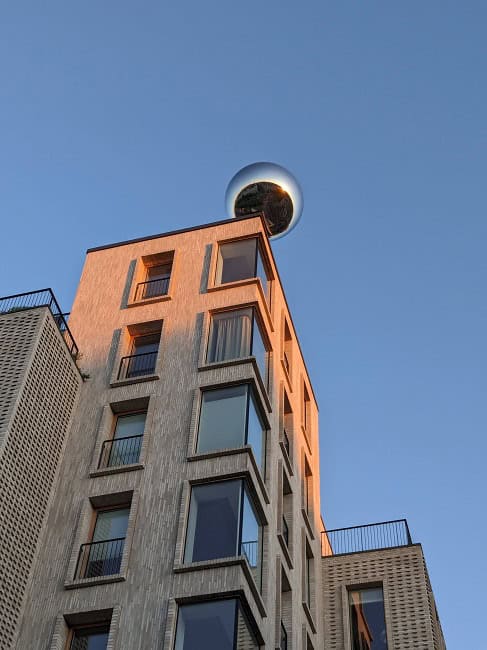 A cool art display in Frederiksberg. The steel ball moves around the roof of the building