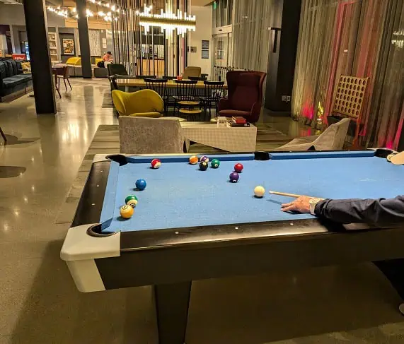 Hanging out at night, playing pool with co-workers
